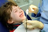Pediatric Dental Care happy little girl at a dentist examination and teeth medical treatment